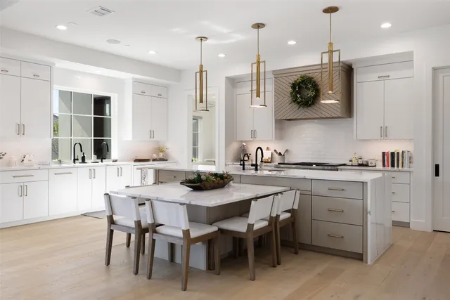 a kitchen with white cabinets and refrigerator