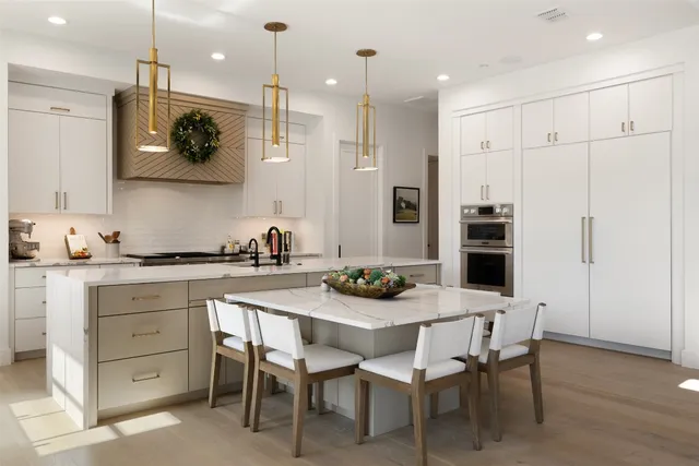 a kitchen with a sink and chairs