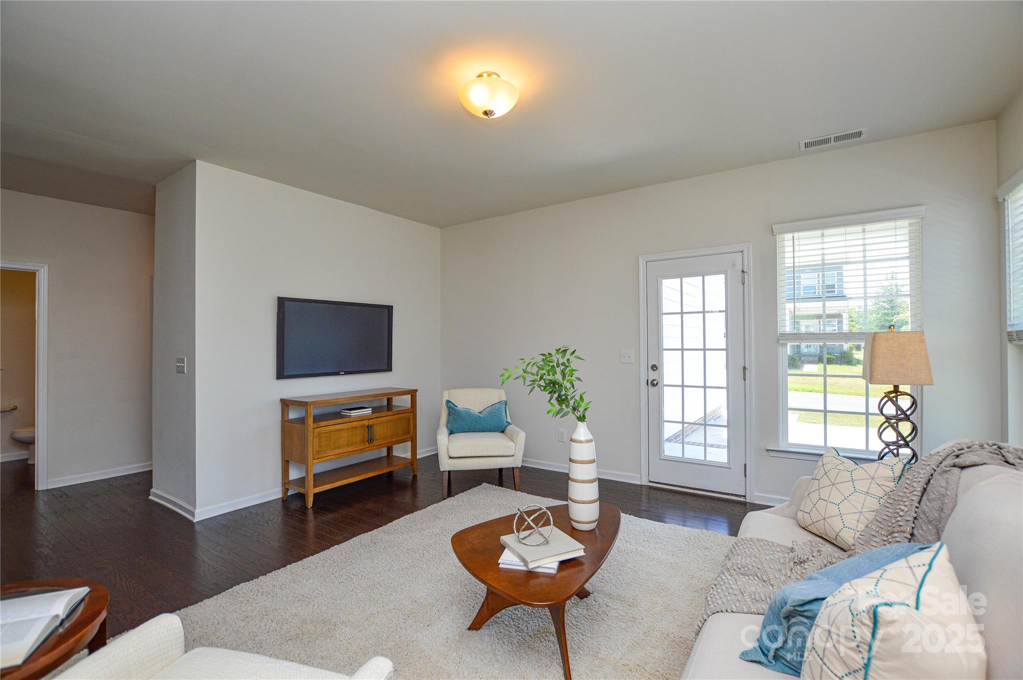 6096 Cloverdale Drive Fort Mill, SC 29708 - Photo 13 of 48 a living room with furniture a flat screen tv and a window