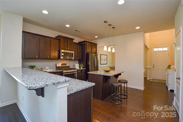 a kitchen with a sink stove and wooden cabinets