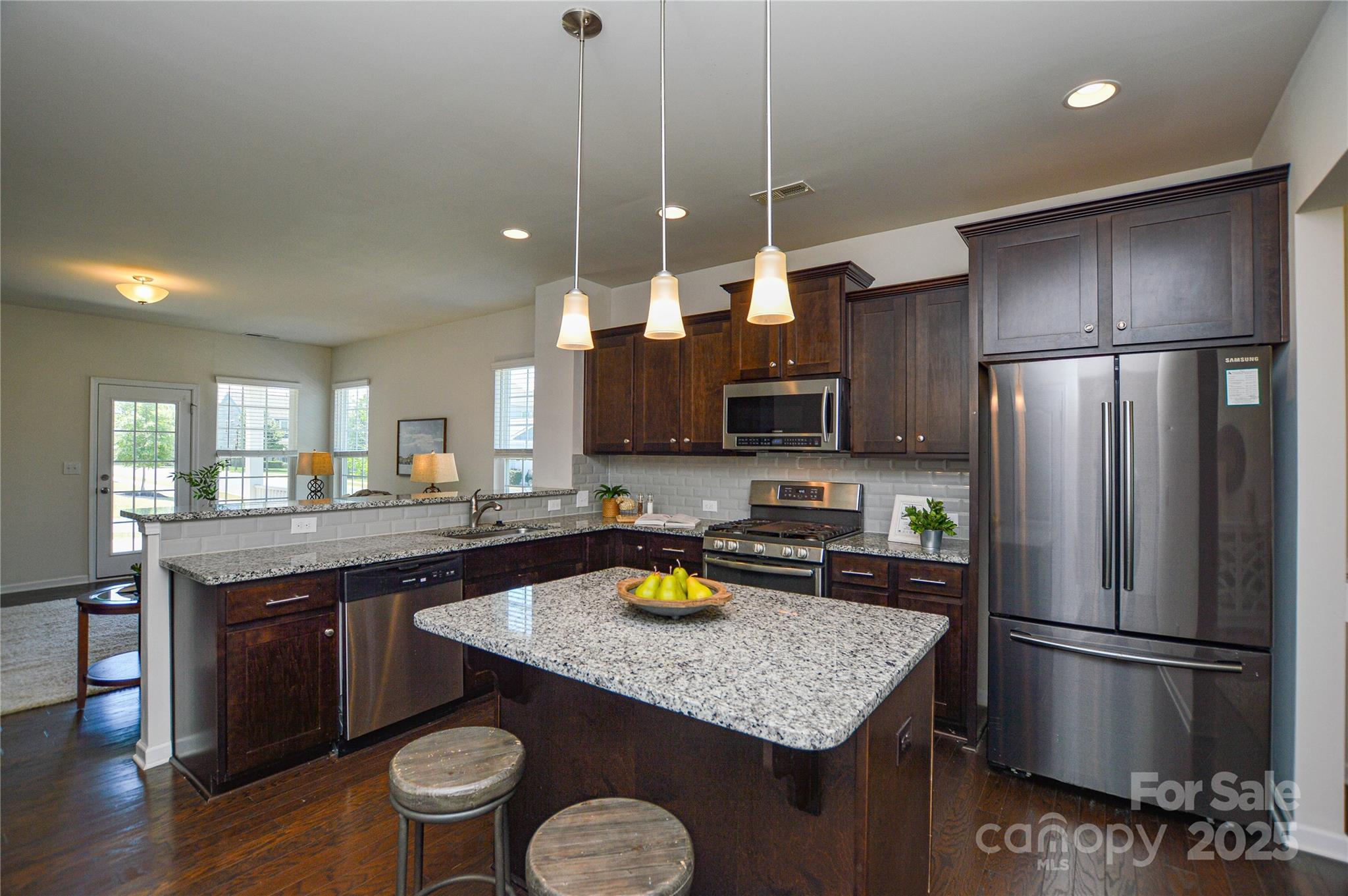 6096 Cloverdale Drive Fort Mill, SC 29708 - Photo 15 of 48 a kitchen with refrigerator a sink and chairs
