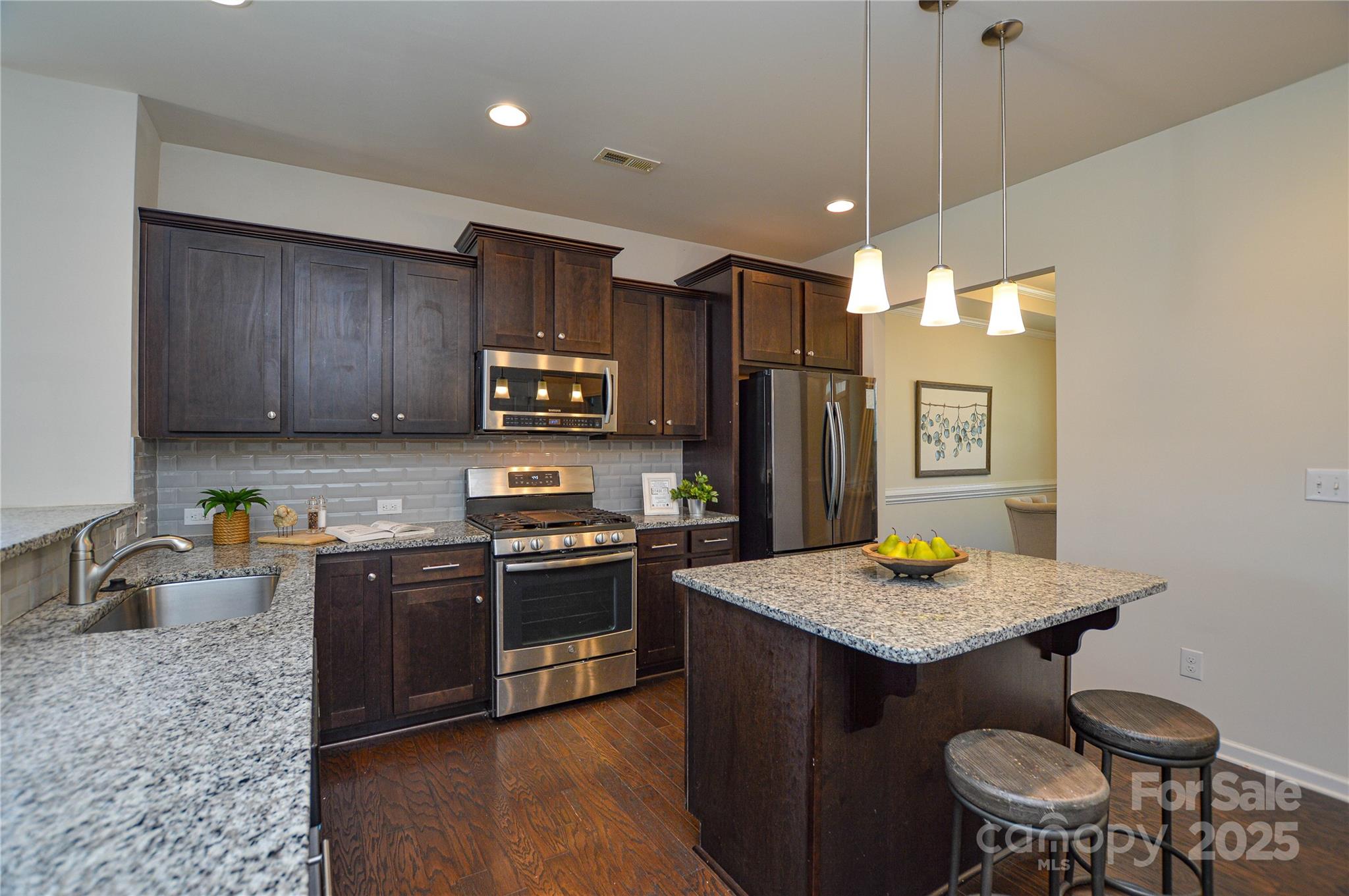 6096 Cloverdale Drive Fort Mill, SC 29708 - Photo 16 of 48 a kitchen with granite countertop wooden cabinets and stainless steel appliances