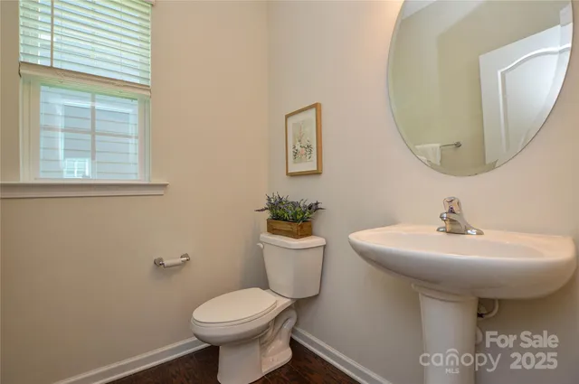 a bathroom with a sink mirror and toilet