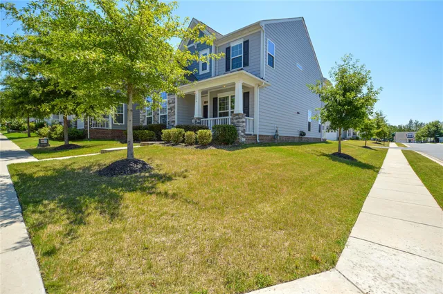 a view of swimming pool with outdoor seating and house in the background