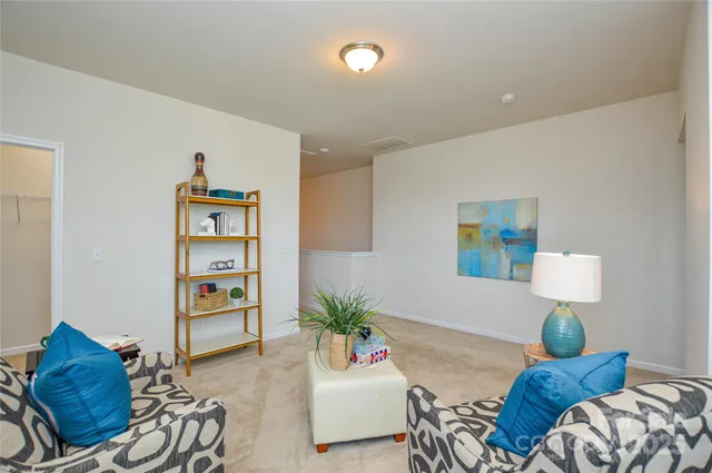 a living room with furniture flowerpot and a window