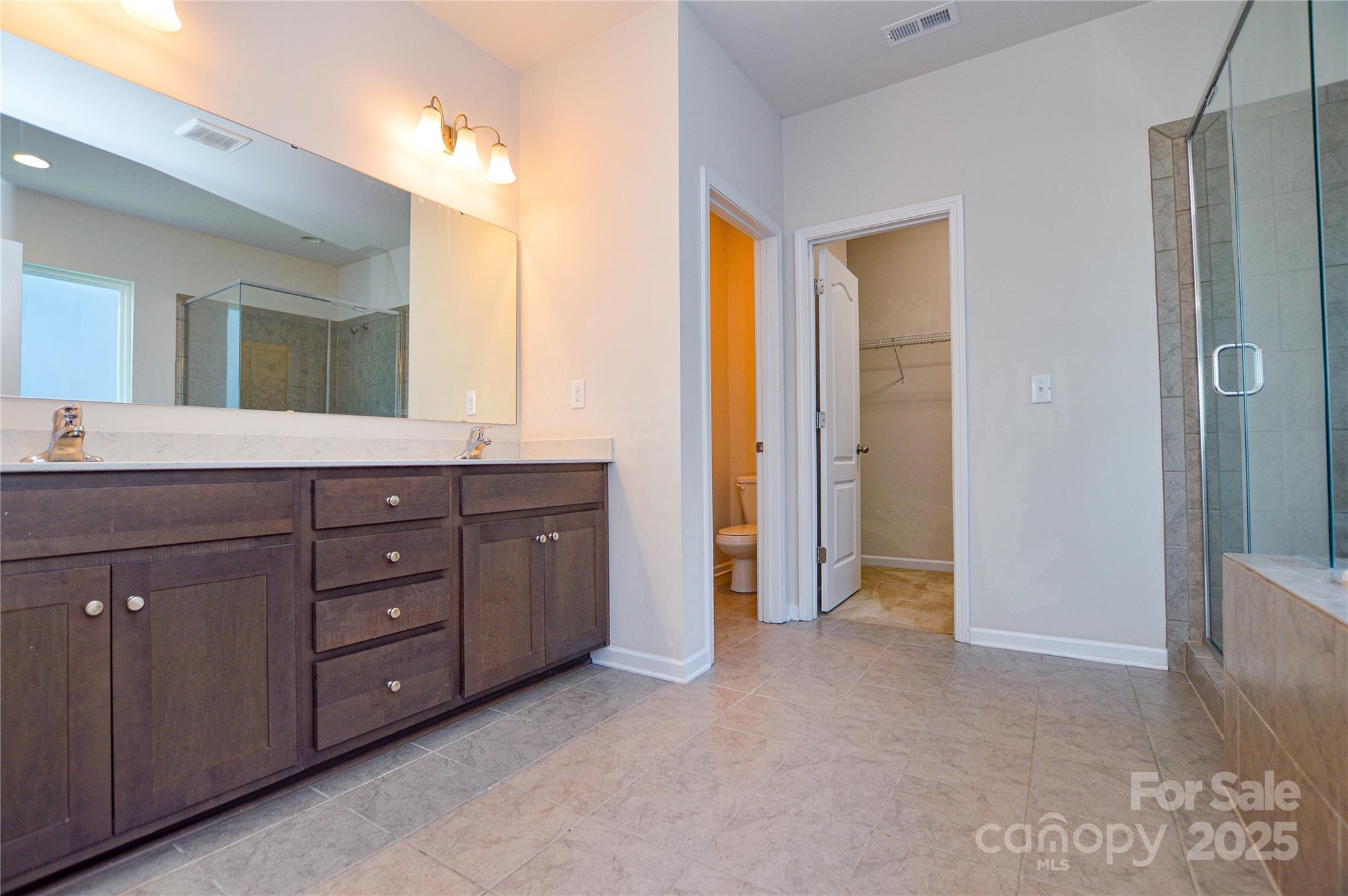 6096 Cloverdale Drive Fort Mill, SC 29708 - Photo 39 of 48 a spacious bathroom with a granite countertop sink and a mirror