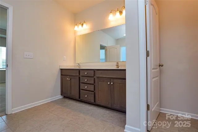 a spacious bathroom with a granite countertop sink and a mirror