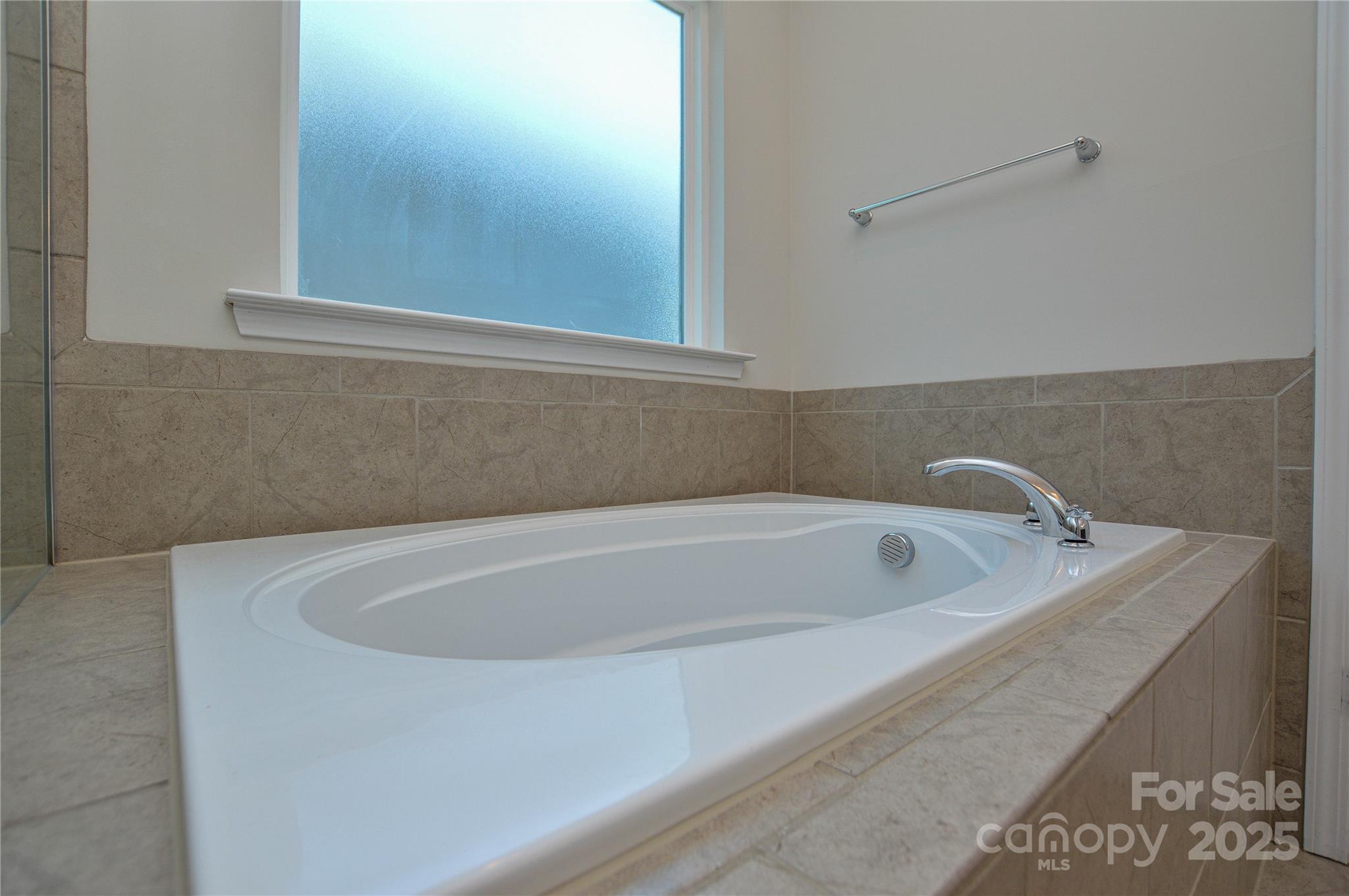 6096 Cloverdale Drive Fort Mill, SC 29708 - Photo 42 of 48 a bath tub sitting in a bathroom next to a white sink