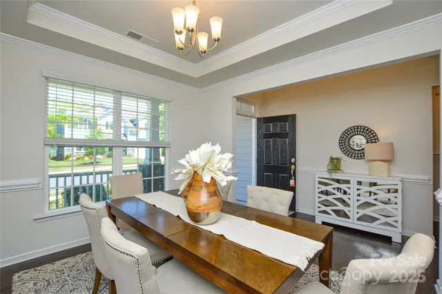 a view of a dining room with furniture and chandelier