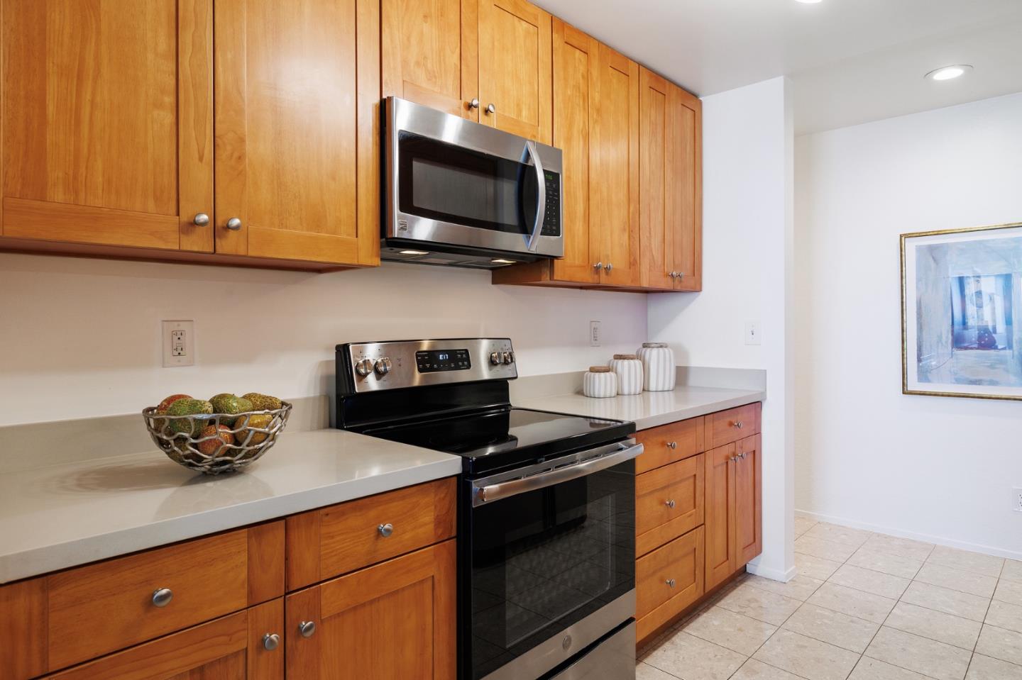 360 Vallejo Drive, Unit 113 Millbrae, CA 94030 - Photo 11 of 34 a kitchen with stainless steel appliances granite countertop a sink a stove and a microwave