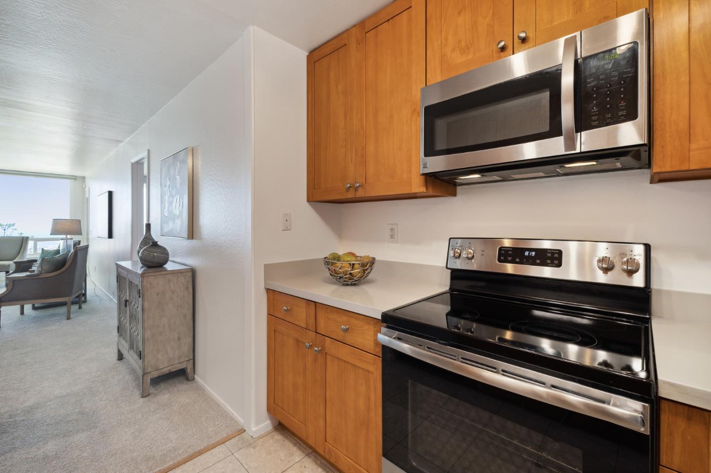 360 Vallejo Drive, Unit 113 Millbrae, CA 94030 - Photo 12 of 34 a kitchen with a stove and a microwave