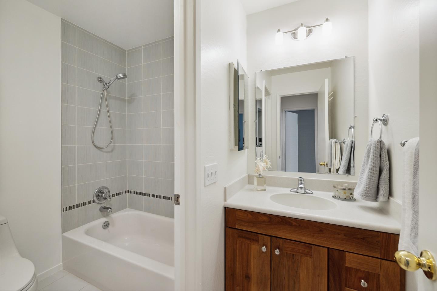 360 Vallejo Drive, Unit 113 Millbrae, CA 94030 - Photo 30 of 34 a bathroom with a tub sink and mirror