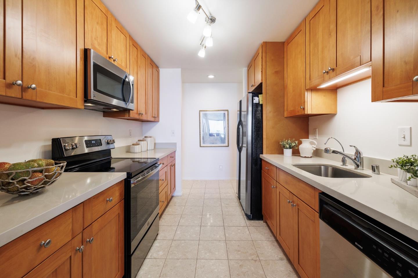 360 Vallejo Drive, Unit 113 Millbrae, CA 94030 - Photo 10 of 34 a kitchen with stainless steel appliances granite countertop a sink a stove and a refrigerator