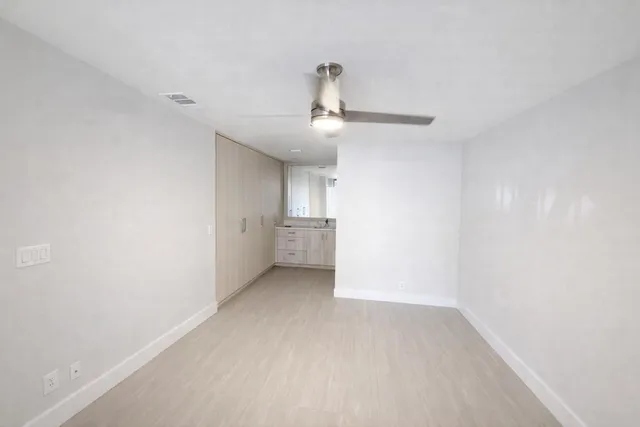 a bathroom with a toilet sink vanity and mirror