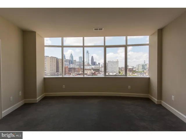 a view of lot of an empty room with a large window