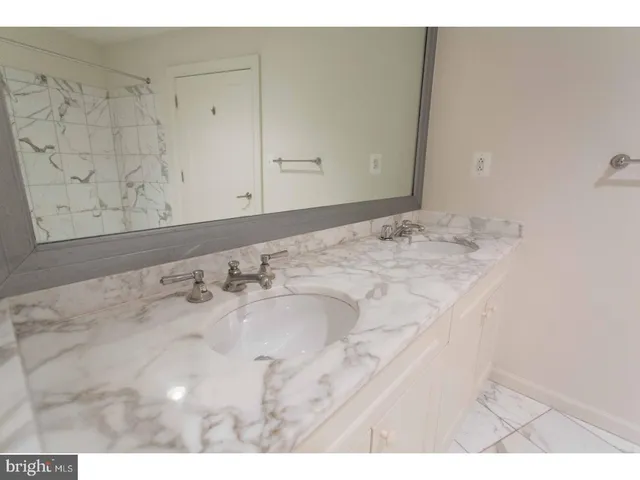 a bathroom with a sink vanity and granite