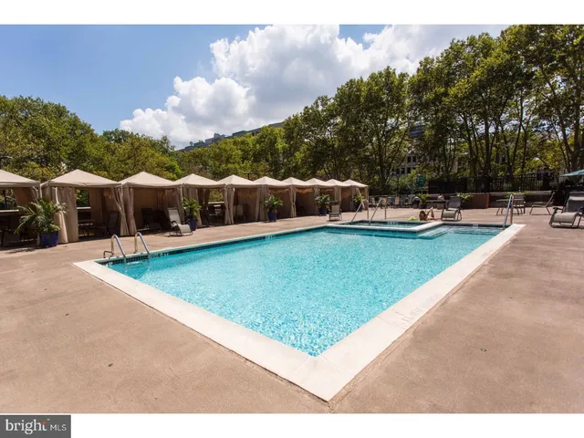 a view of a house with swimming pool and sitting area