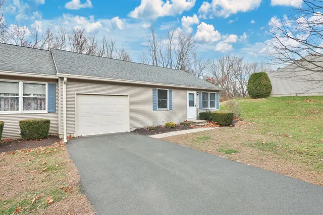 a view of a house with a snow in the yard