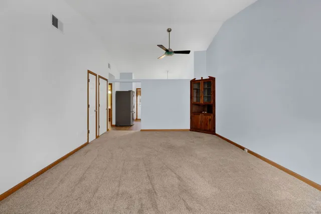 a view of empty room with ceiling fan