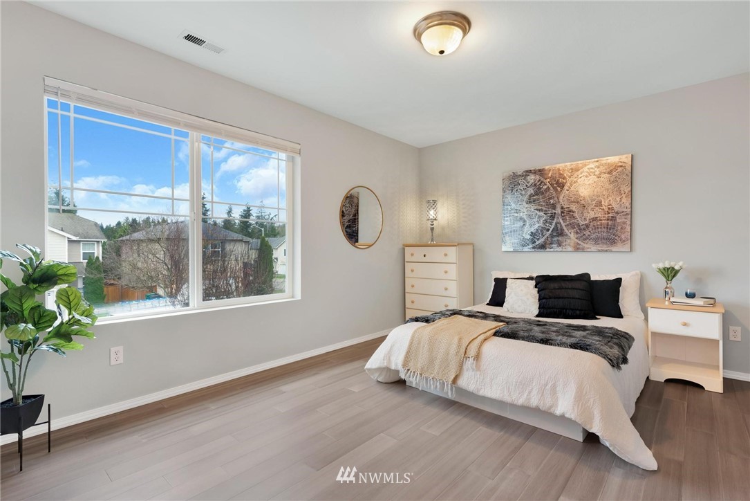 15429 38th Drive Southeast Bothell, WA 98012 - Photo 18 of 26 a bedroom with a bed and a large window
