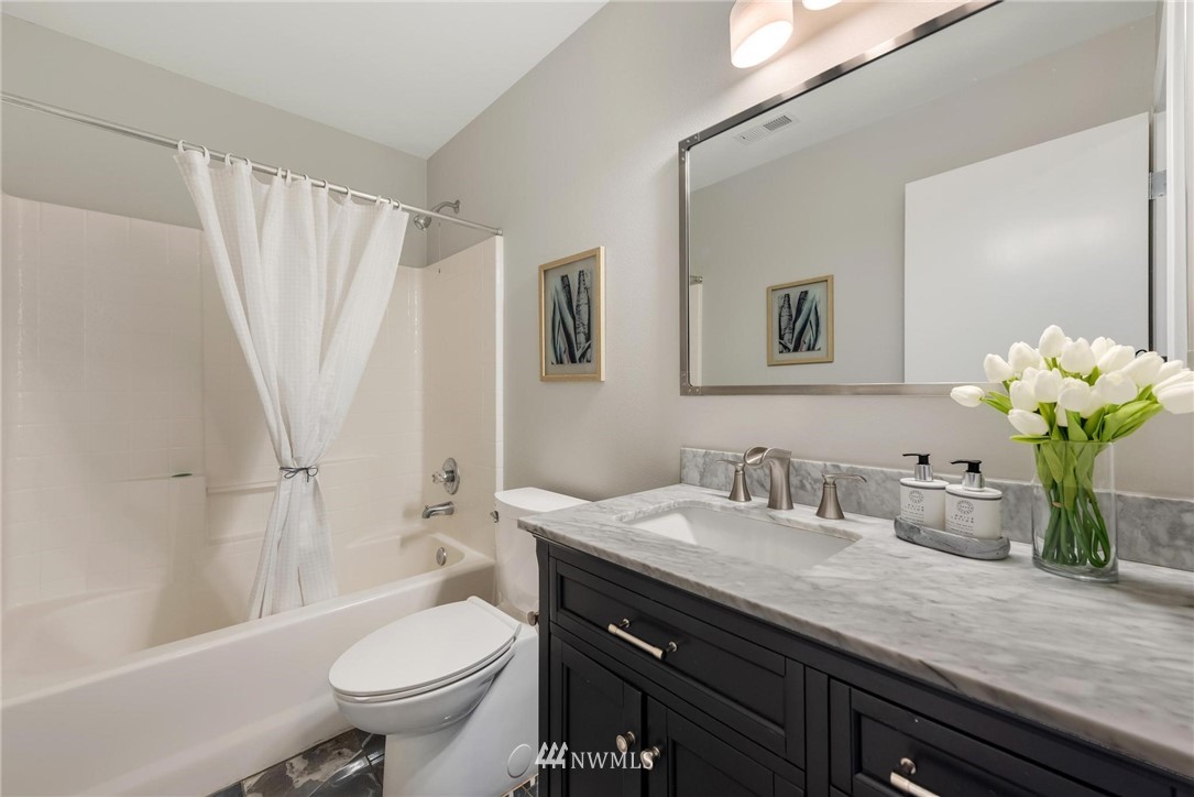 15429 38th Drive Southeast Bothell, WA 98012 - Photo 20 of 26 a bathroom with a granite countertop sink toilet and shower