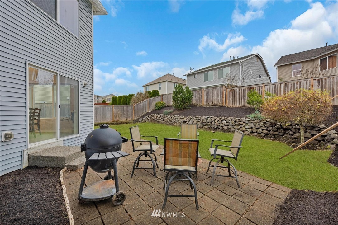 15429 38th Drive Southeast Bothell, WA 98012 - Photo 22 of 26 a chairs and a table in a backyard of the house