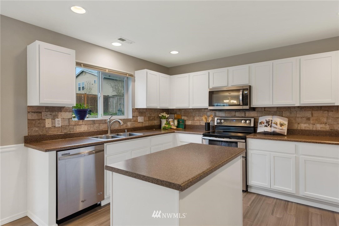 15429 38th Drive Southeast Bothell, WA 98012 - Photo 8 of 26 a kitchen with a sink a stove a microwave and cabinets