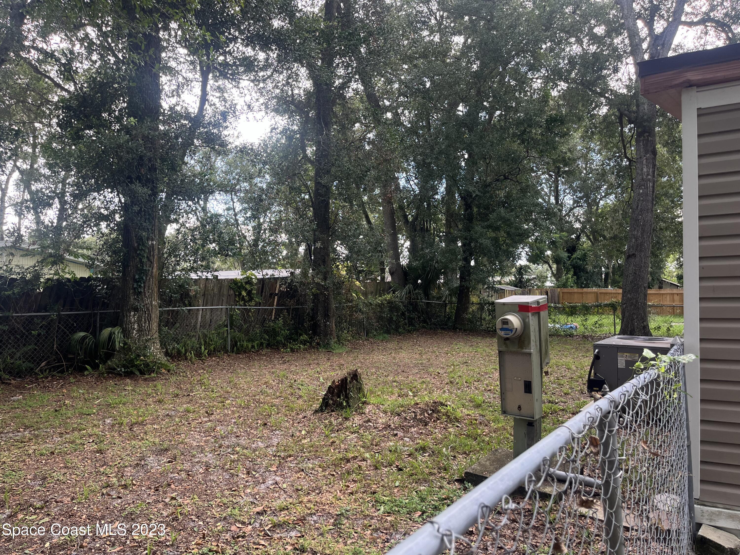 421 Cross Road Cocoa, FL 32926 - Photo 17 of 18 a view of a wooden deck with trees and wooden fence