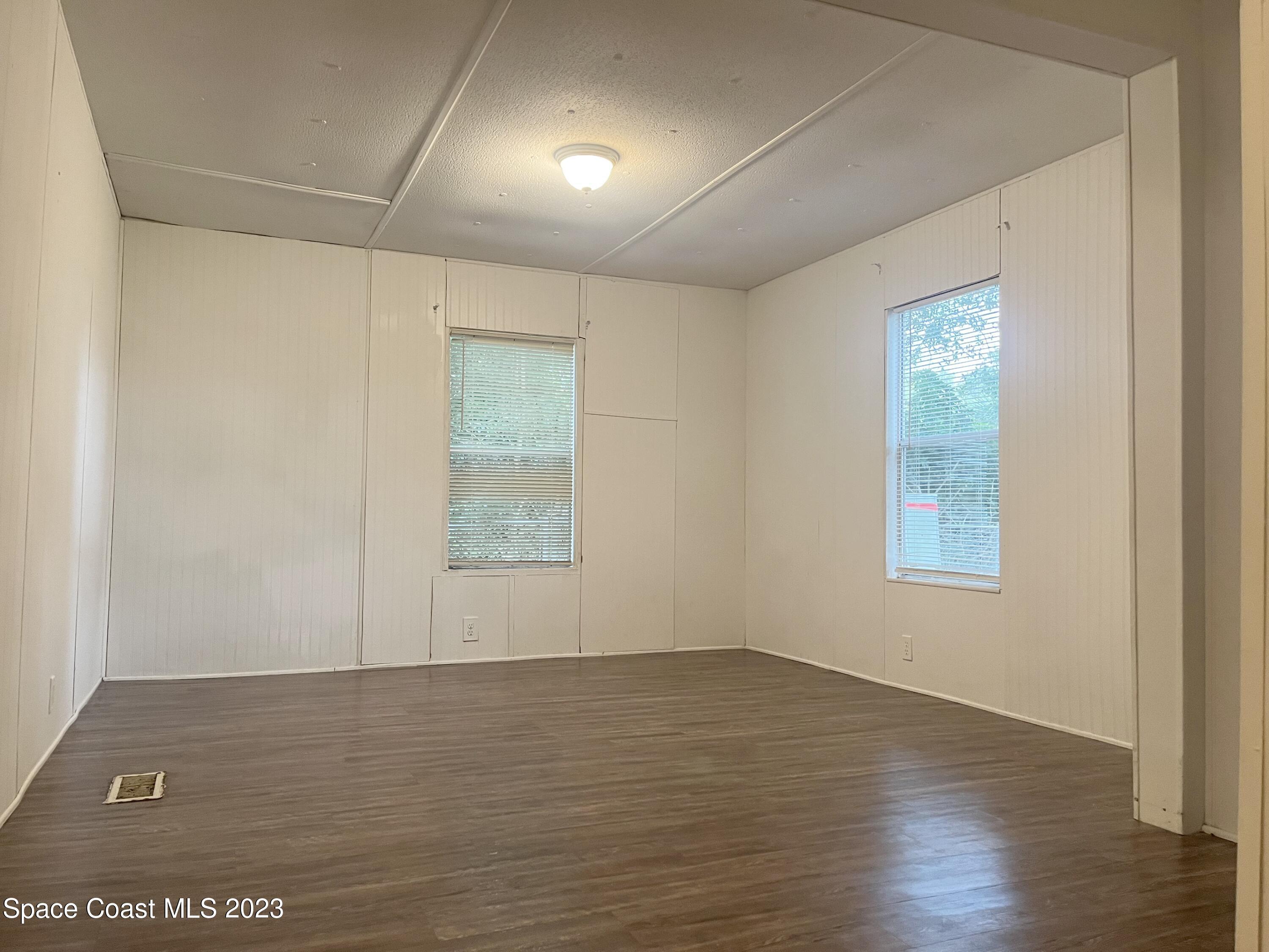 421 Cross Road Cocoa, FL 32926 - Photo 7 of 18 an empty room with wooden floor and windows