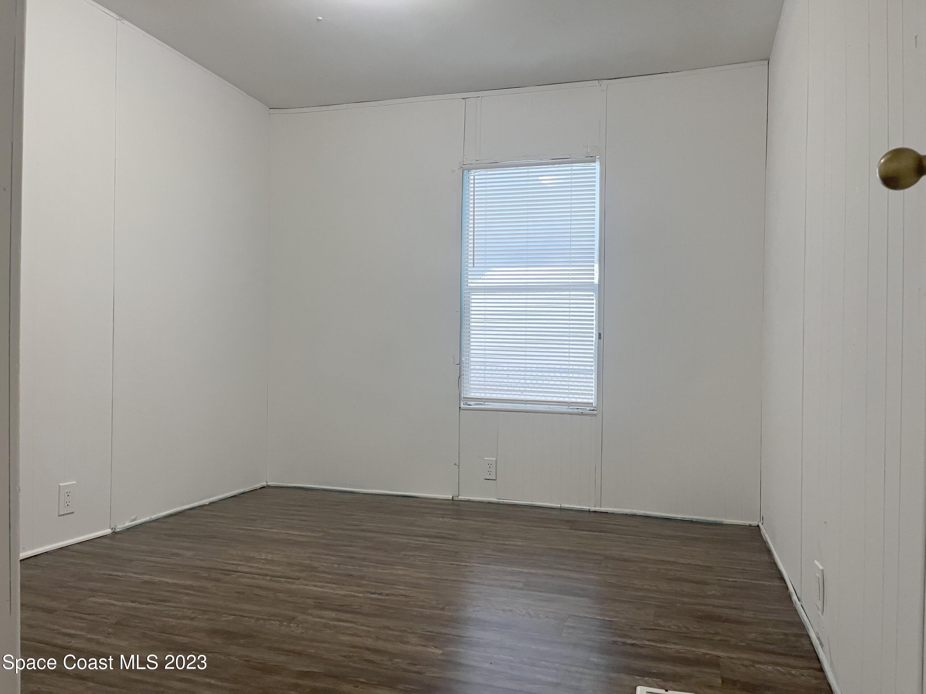 421 Cross Road Cocoa, FL 32926 - Photo 10 of 18 an empty room with wooden floor and windows