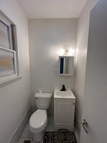a white toilet sitting next to a bathroom sink