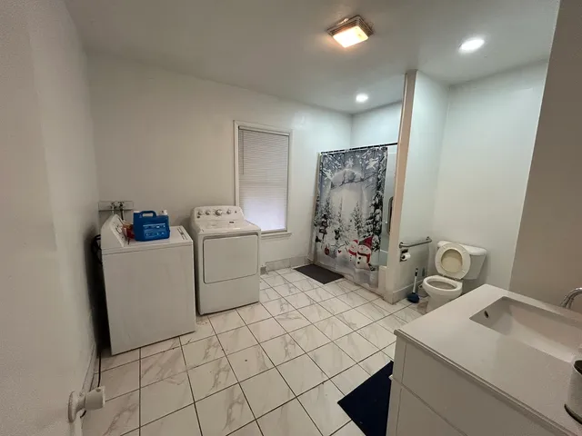 a room with a washing machine and sink