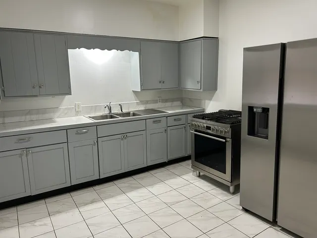 a kitchen with a sink stove and refrigerator