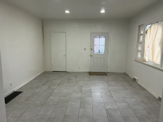 an empty room with windows and closet