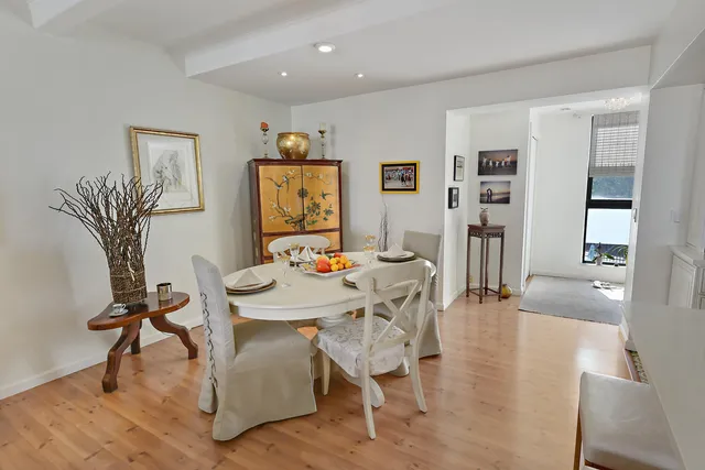 a view of a hallway with windows and white walls