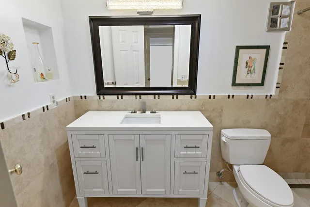 a bedroom with a bed and a flat tv screen on the dresser