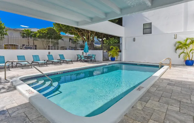 a backyard of a house with table and chairs