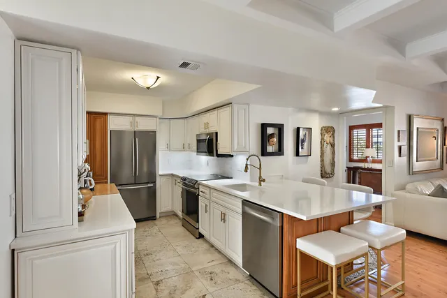 a kitchen with a table chairs stove and kitchen island