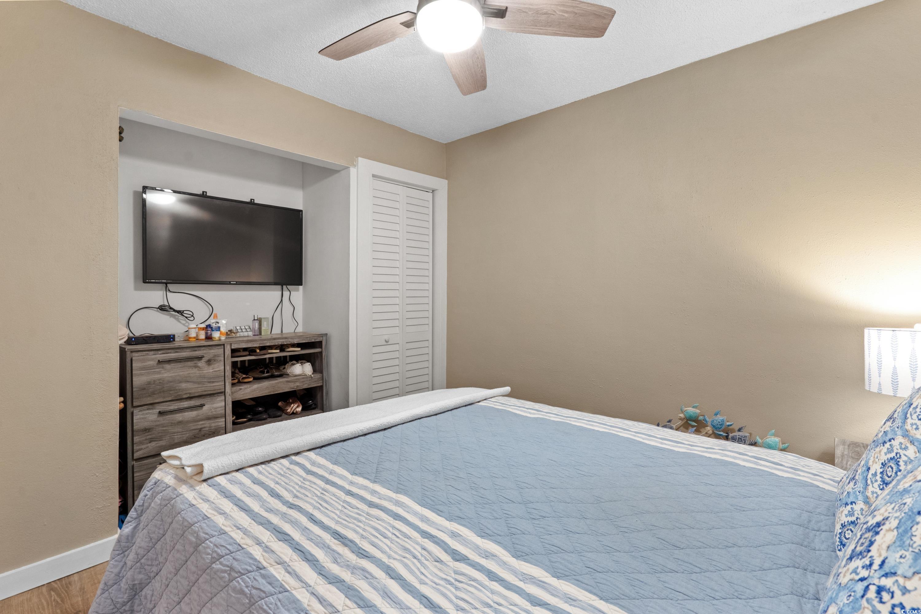 625 North Waccamaw Drive, Unit 107 Murrells Inlet, SC 29576 - Photo 16 of 37 Bedroom featuring wood finished floors, baseboards, and ceiling fan