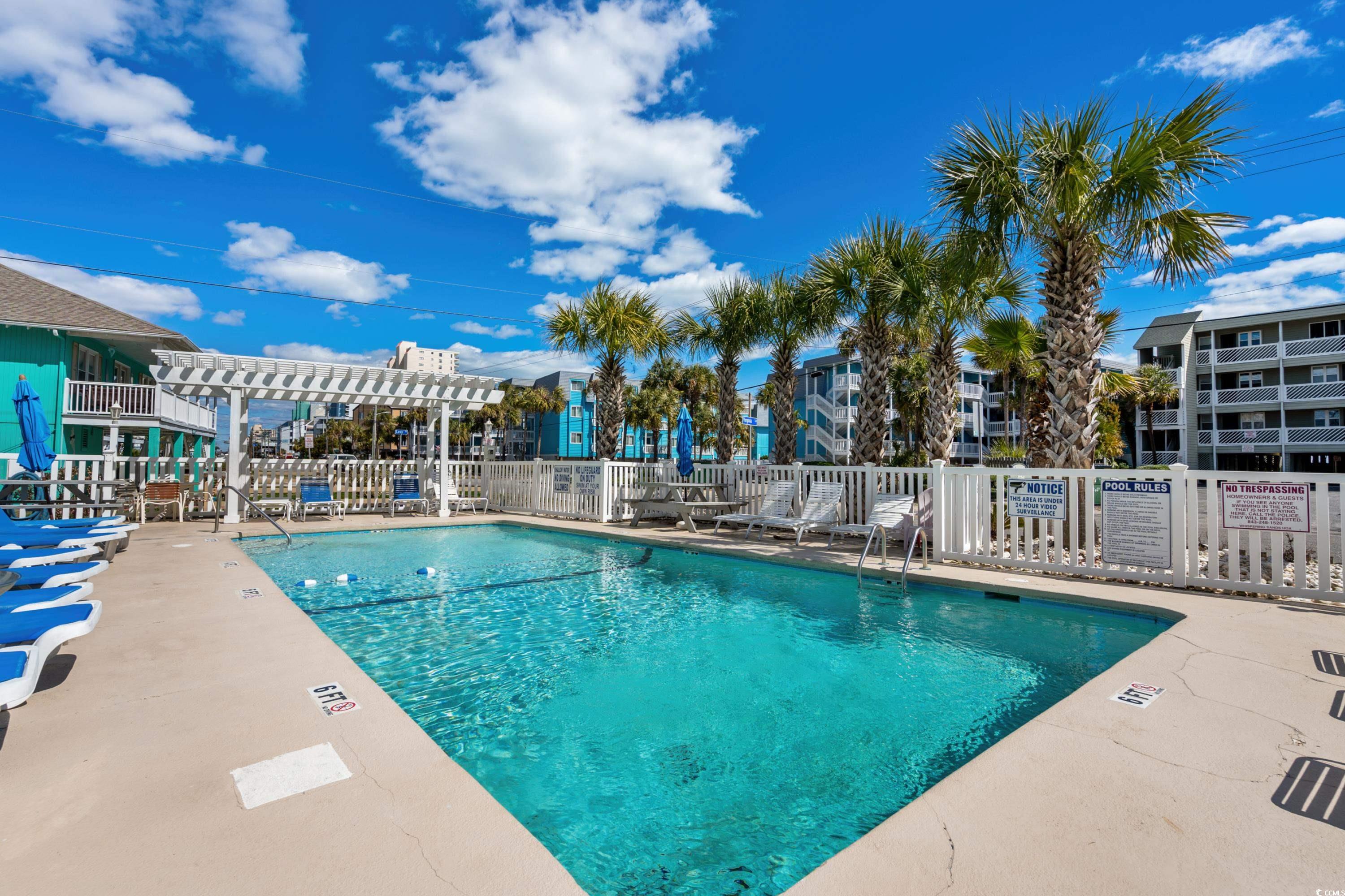 625 North Waccamaw Drive, Unit 107 Murrells Inlet, SC 29576 - Photo 25 of 37 Community pool with fence, a pergola, and a patio area