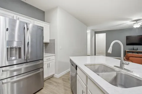 a kitchen with a refrigerator and a sink