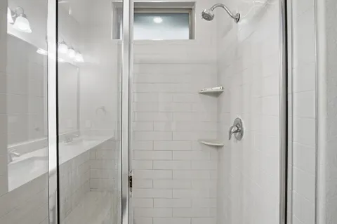 a bathroom with a glass shower door