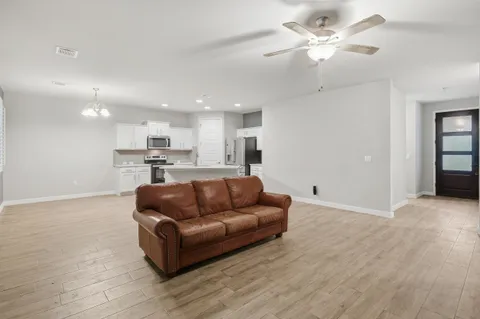 a living room with furniture and kitchen view