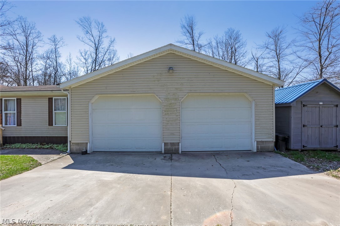 4502 Clover Road Cumberland, OH 43732 - Photo 5 of 38 Garage with concrete driveway and a shed