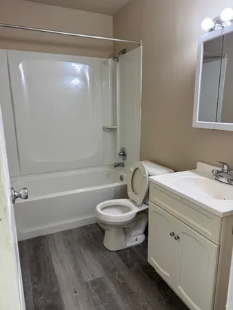 a bathroom with a toilet a sink and bathtub