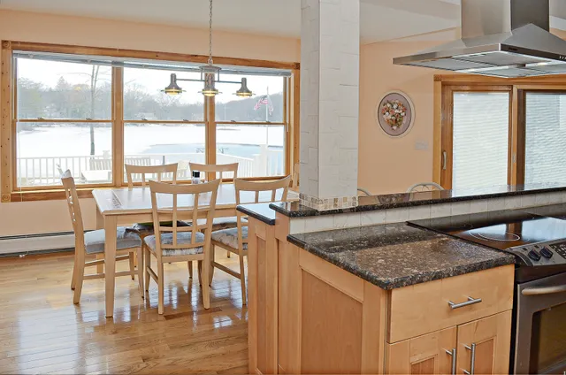 a view of a kitchen counter top space with furniture and wooden floor