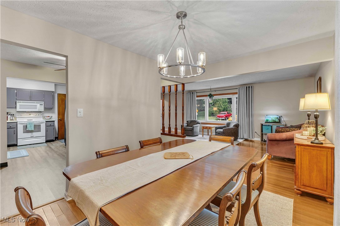 4090 Ridgeview Road Cleveland, OH 44144 - Photo 5 of 40 Dining space featuring light wood-style floors and a chandelier
