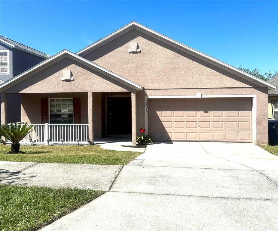 2059 Newtown Road Groveland, FL 34736 - Photo 1 of 1 a front view of a house with a yard