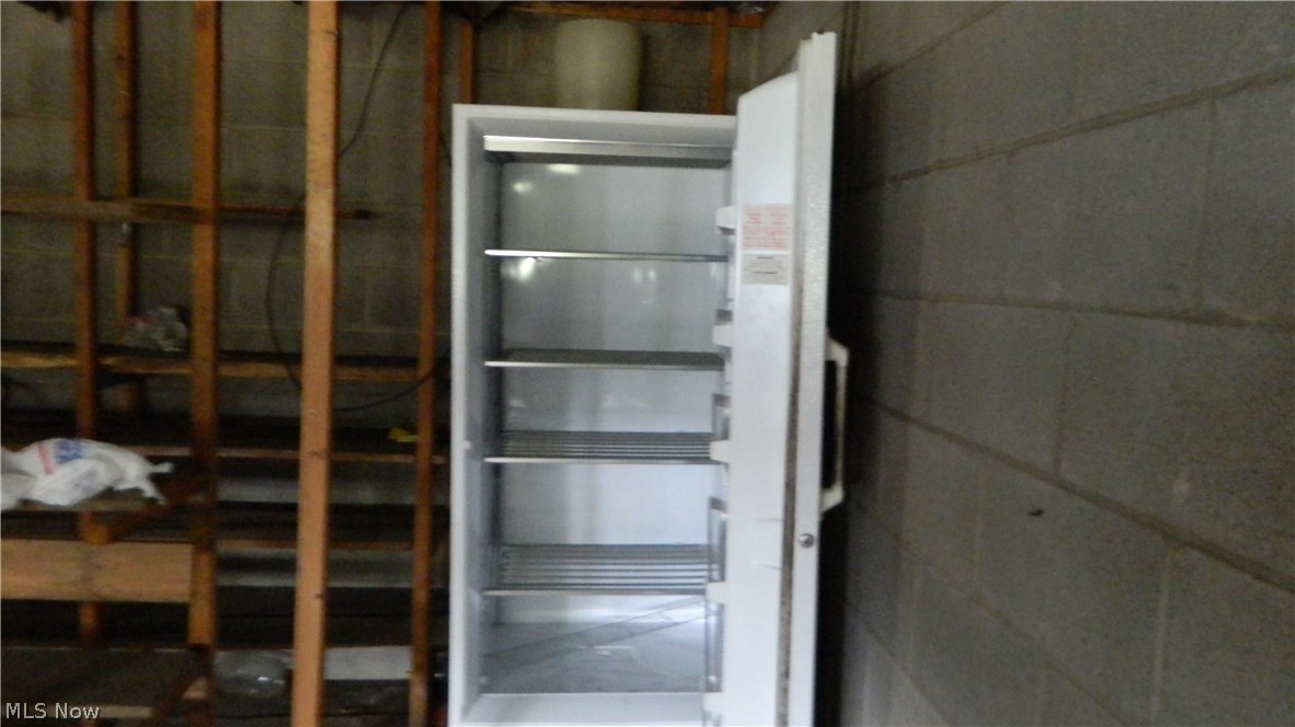 13695 Beaver Springfield Road New Springfield, OH 44443 - Photo 18 of 34 Freezer is in the lower level of the 2 car attached garage, along with ample storage with shelving as well.