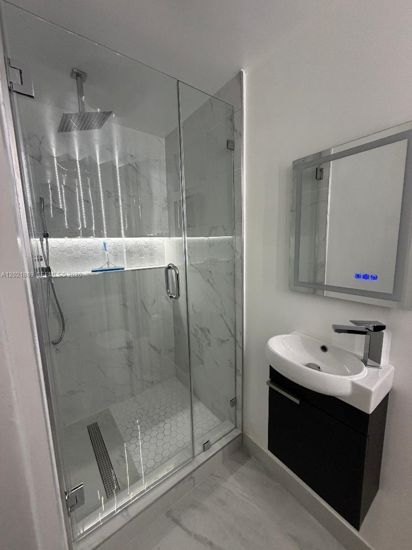 6803 Southwest 158th Avenue Miami, FL 33193 - Photo 4 of 6 a bathroom with a sink and mirror
